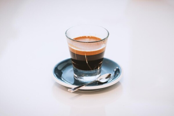 clear glass cup on saucer