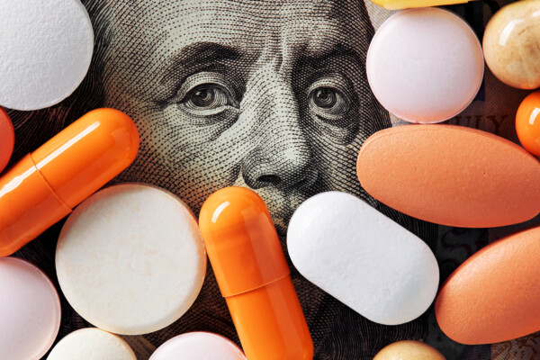 Hundred dollar bill surrounded by pills, drugs