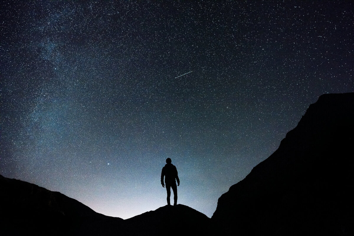 A man looking at a starry night sky