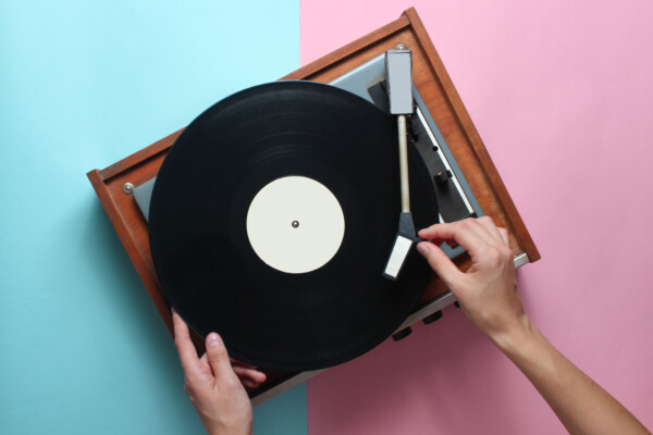 Someone playing music on a record player