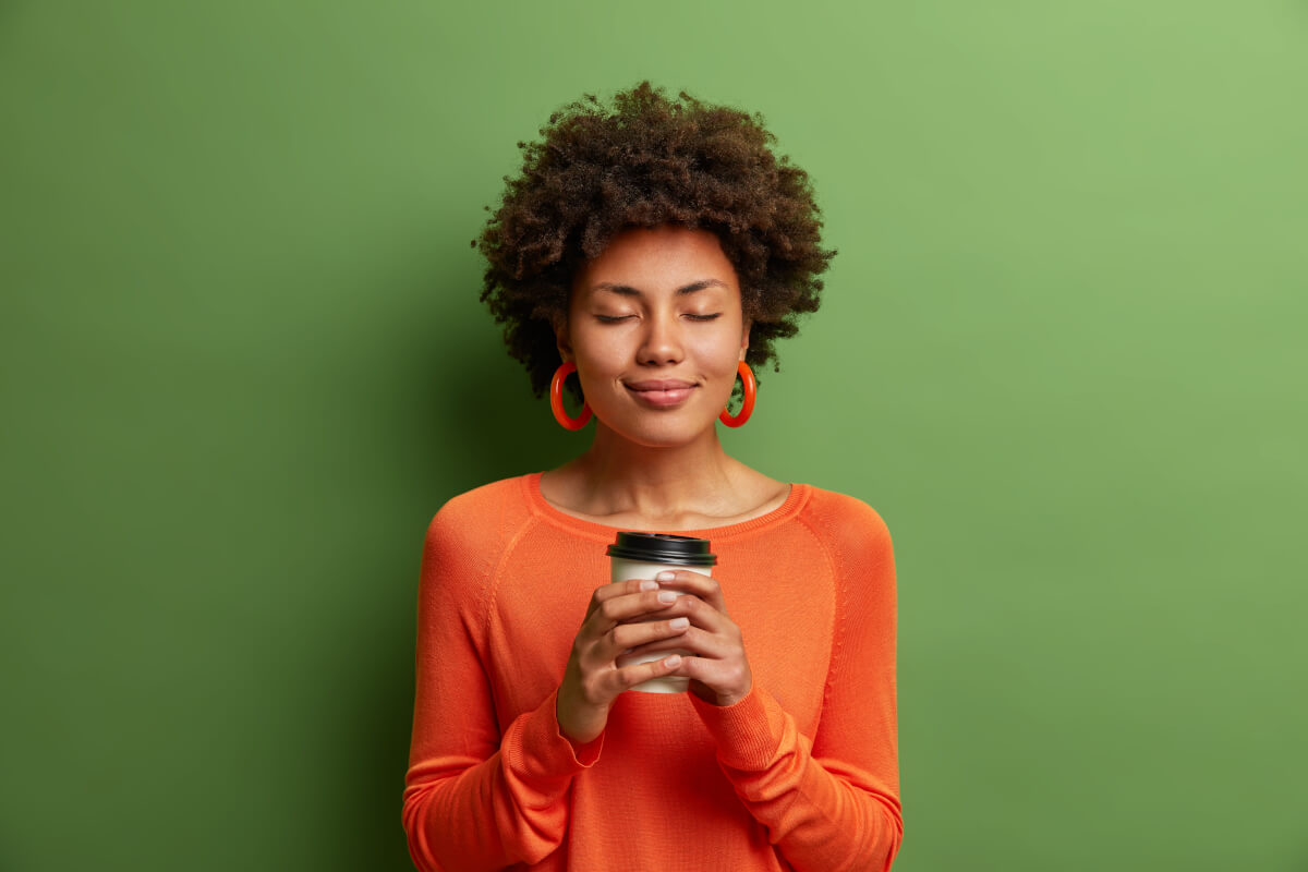 A woman drinking a cup of coffee
