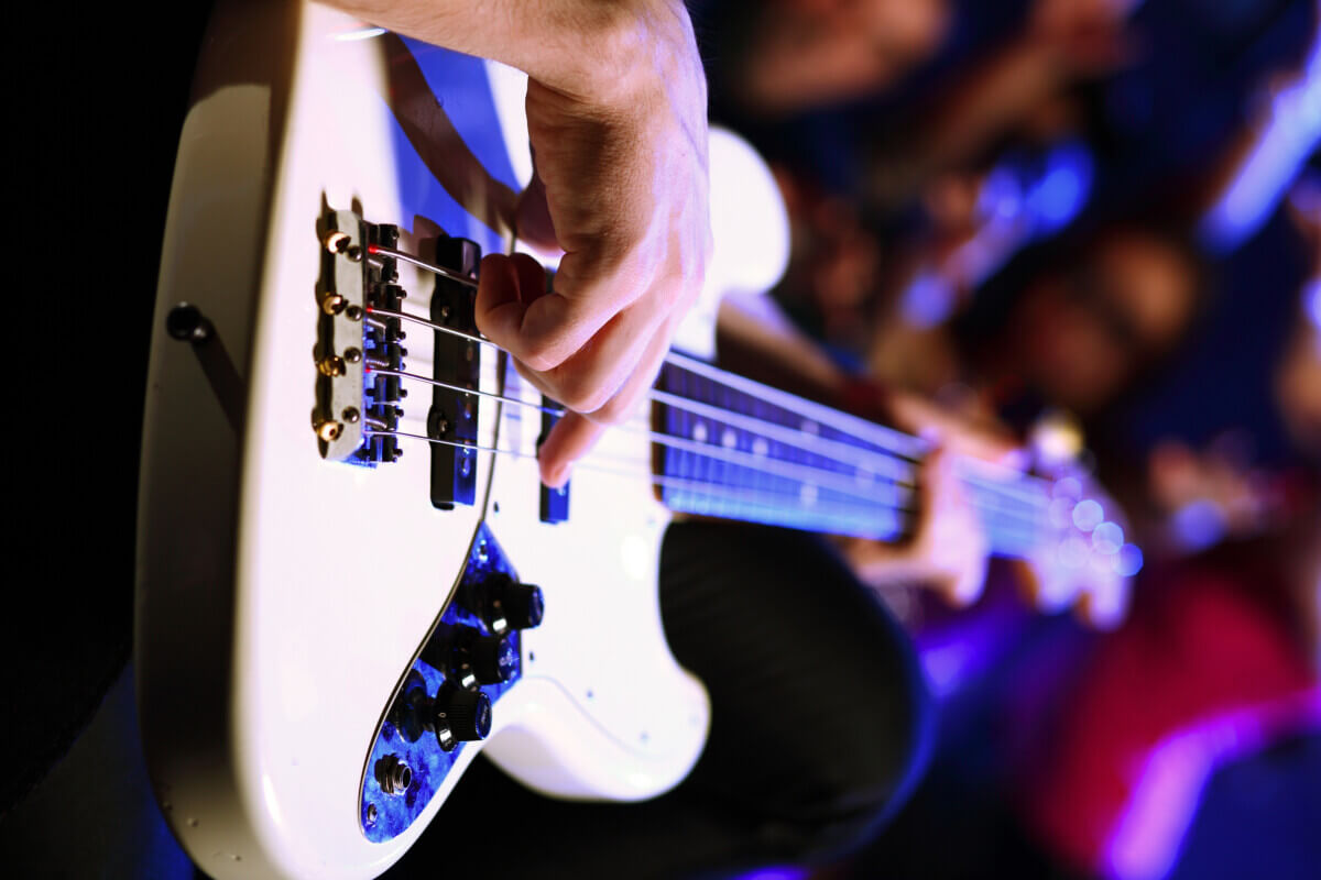 Someone playing a bass guitar