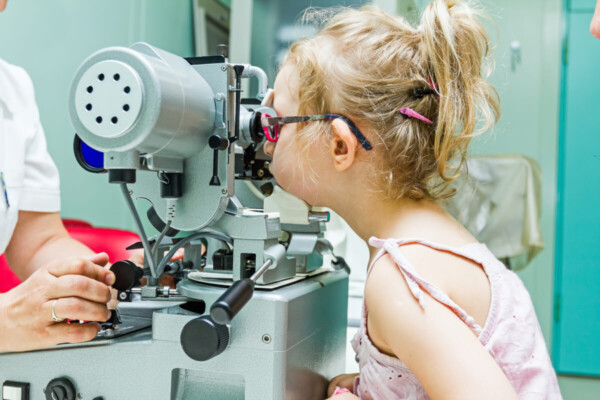 Young girl has a vision test at the eye doctor