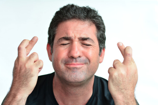 Man crossing fingers for good luck
