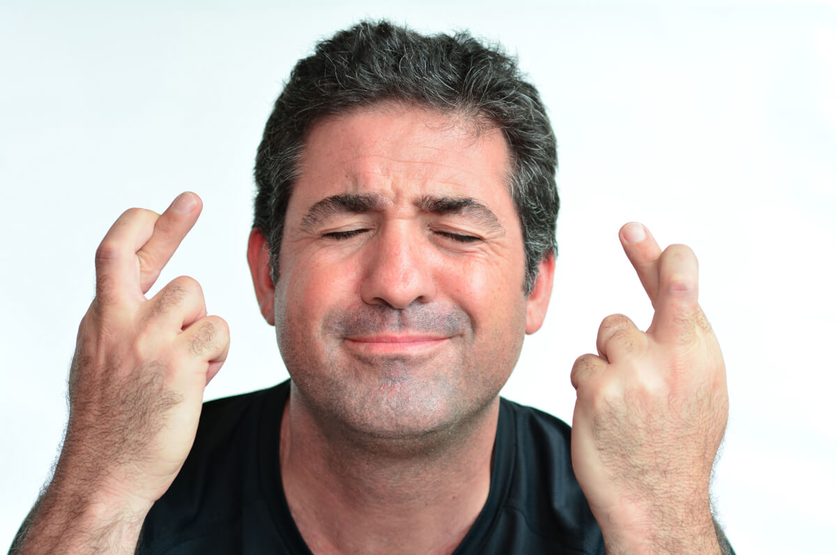 Man crossing fingers for good luck