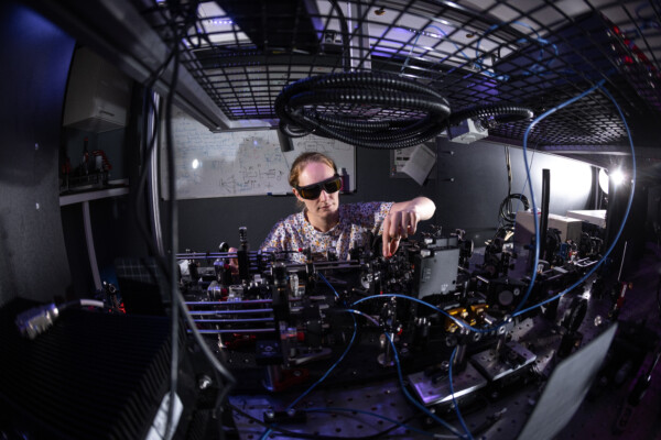 Dr. Sarah Thomas working in the quantum optics lab at Imperial College London.