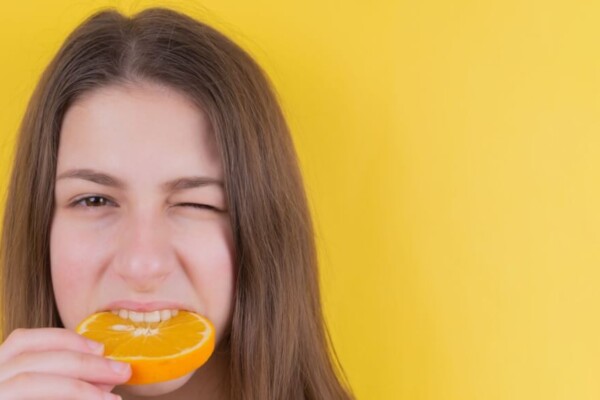 woman eating whole orange