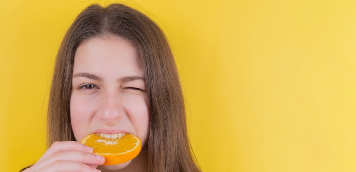 woman eating whole orange