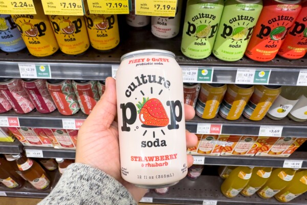 Someone holding a can of Culture Pop probiotic soda in a store