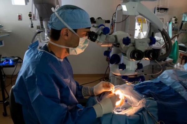 Jason Comander, MD, PhD, performs the procedure to deliver the CRISPR-based medicine as part of the BRILLIANCE trial in September 2020 at Mass Eye and Ear.