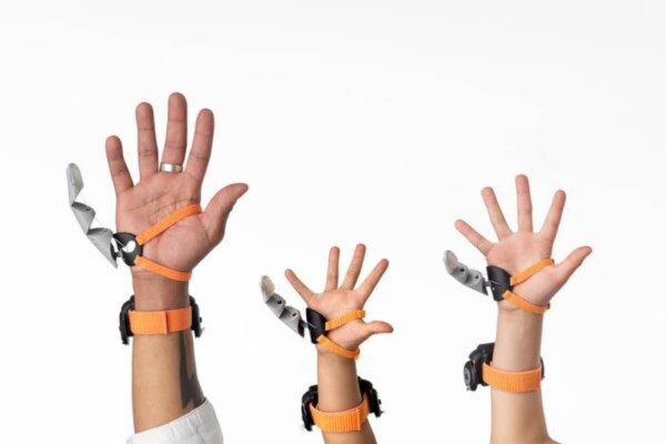 The Third Thumb worn by different users