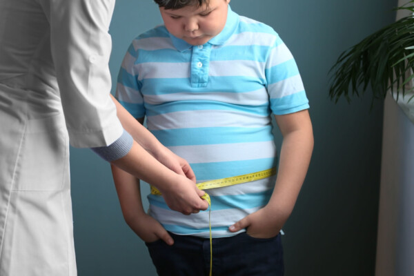 Doctor measuring overweight boy