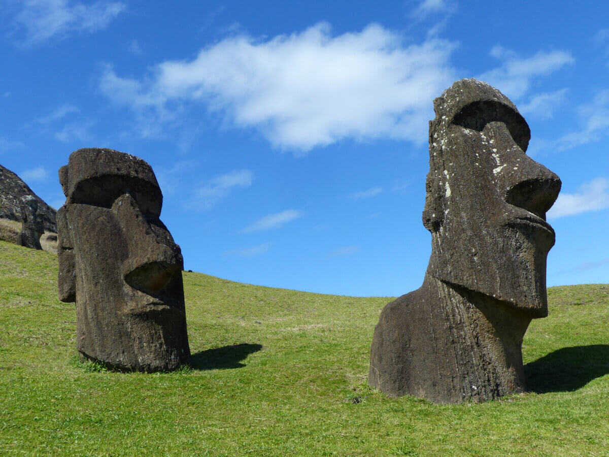 Moai statues under a blue sky at Rano Raraku on Easter Island