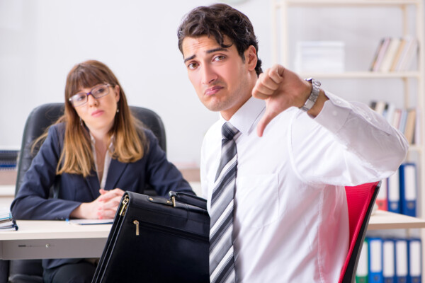 employee giving thumbs down in office