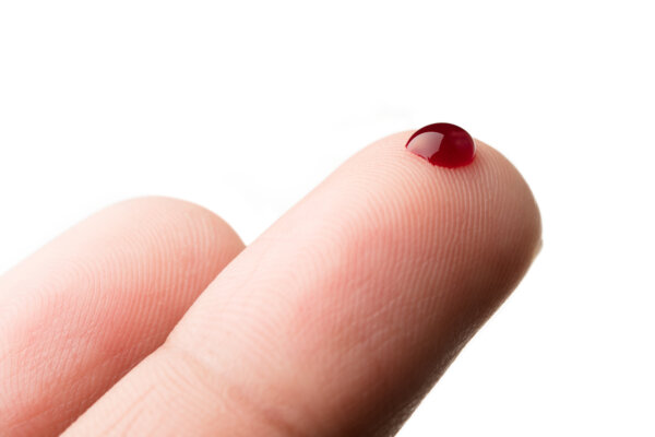 Blood test with drop of blood on finger