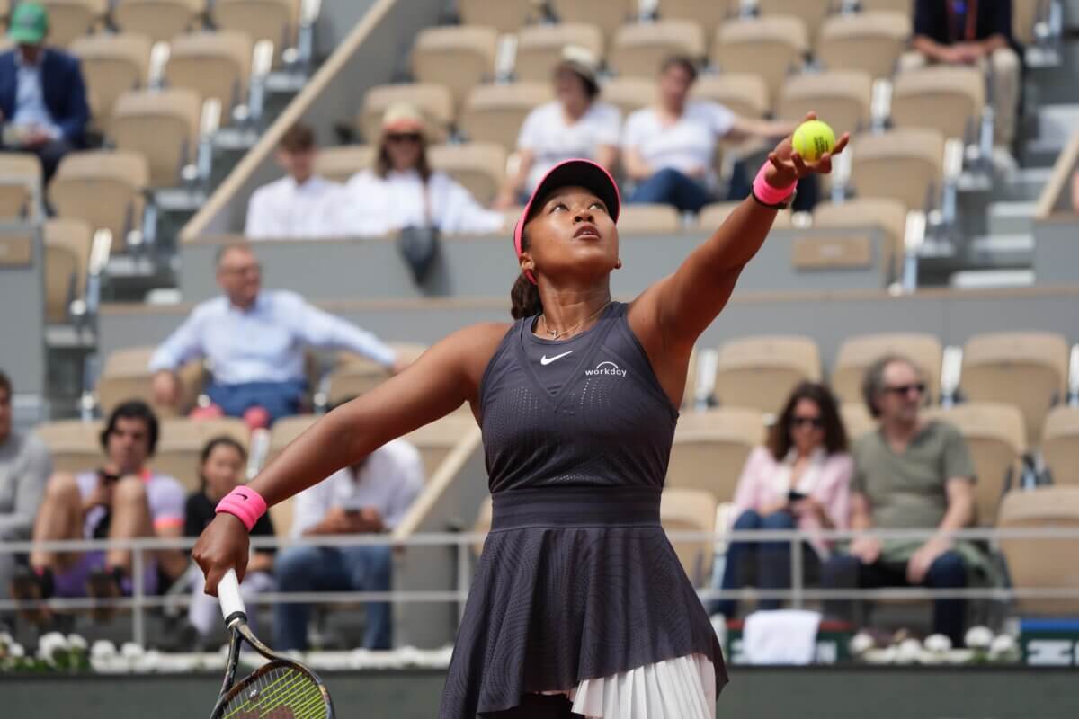 Japanese Naomi Osaka serves in her win against Italy's Lucia Bronzetti in her first round match on court Philippe-Chatrier at the 2024 French Open tennis tournament.