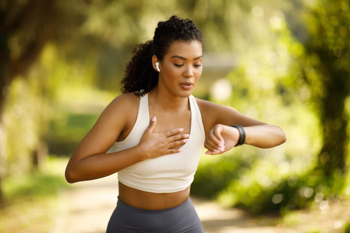 Woman running with fitness tracker