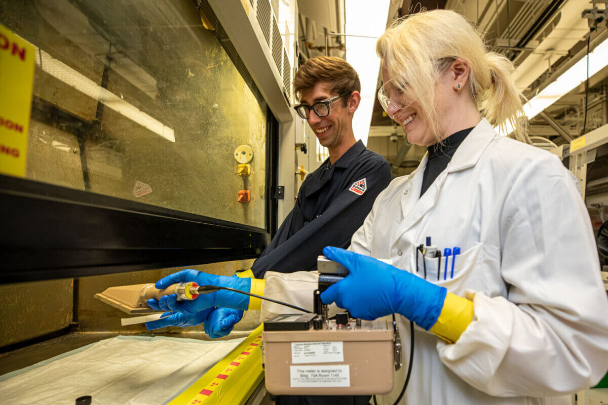 Joshua Woods and Appie Peterson measure a small sample of actinium. 