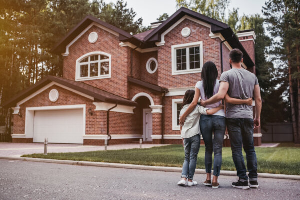 family standing near modern house