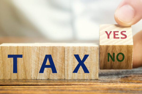 Wooden blocks with the words Tax, yes or no.