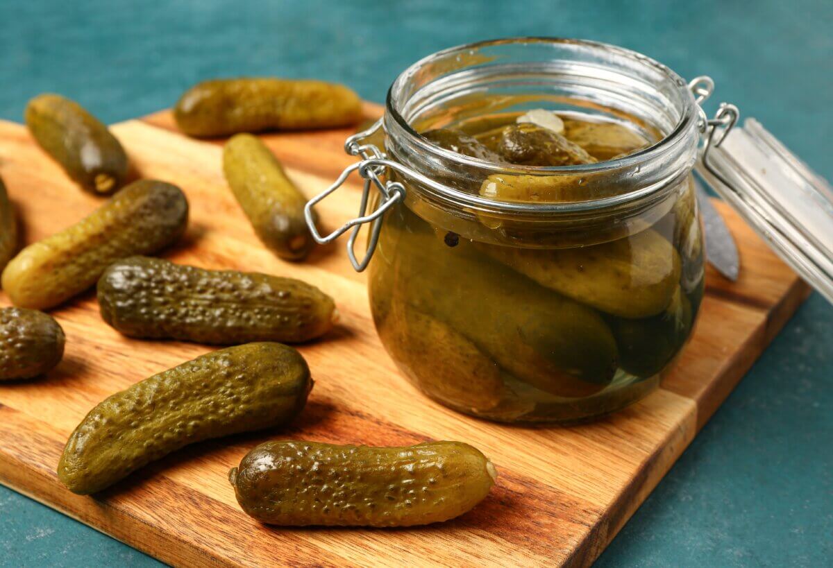 Jar and wooden board with pickles