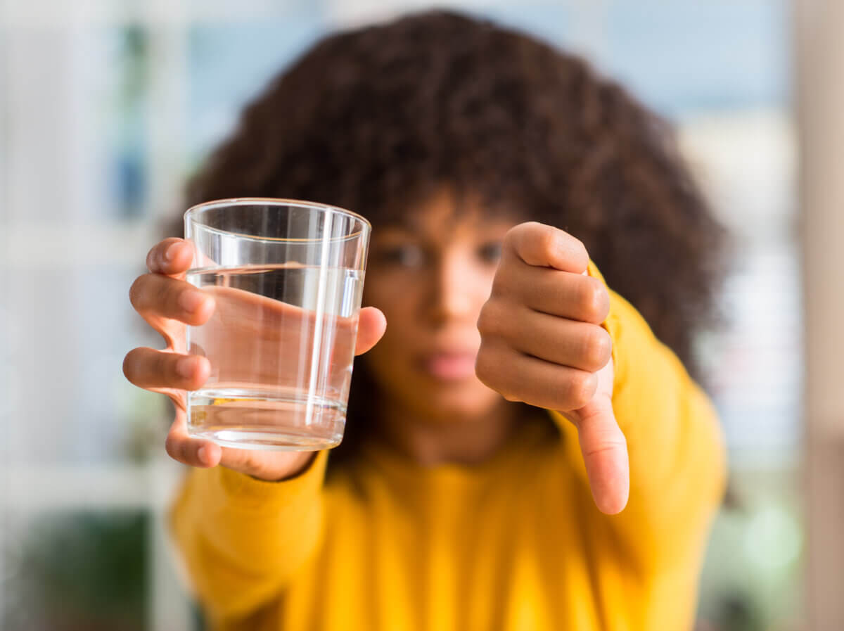 woman rejecting a glass of water