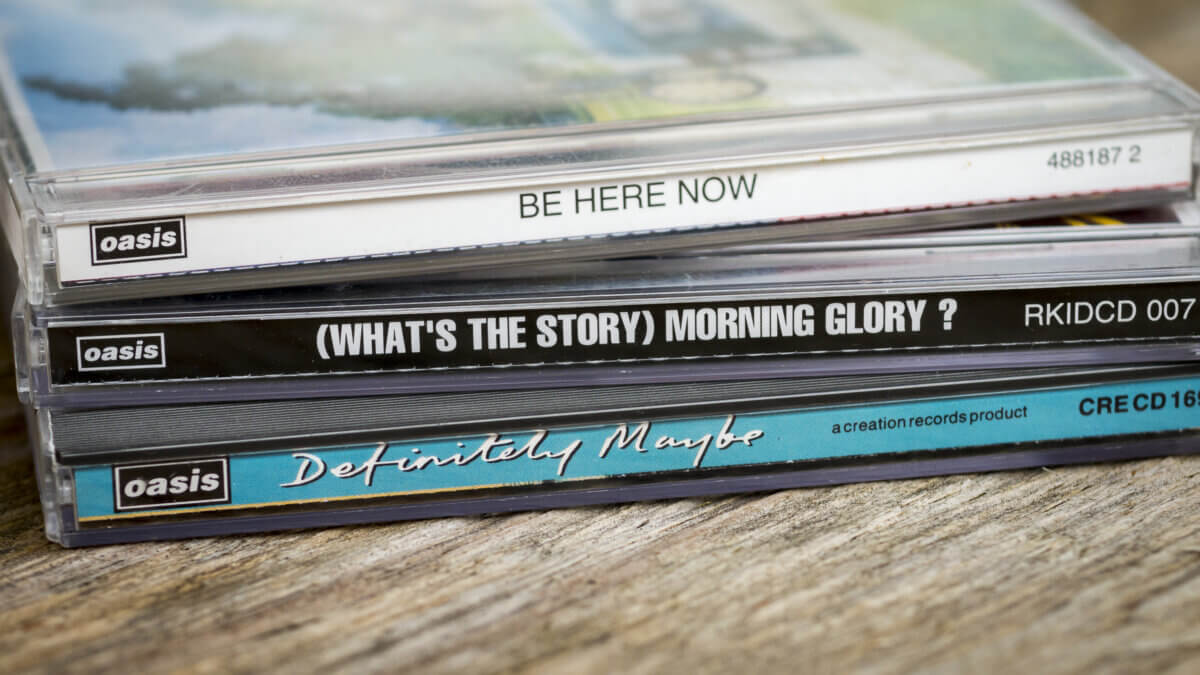 British rock band Oasis first 3 albums launched in the 1990's, Definitely Maybe - 1994, What's The story Morning Glory - 1995, Be Here Now - 1997 on Compact Disc