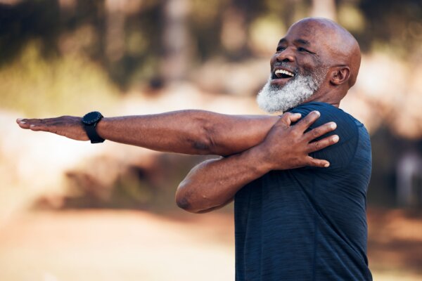 Older man exercising and stretching outside