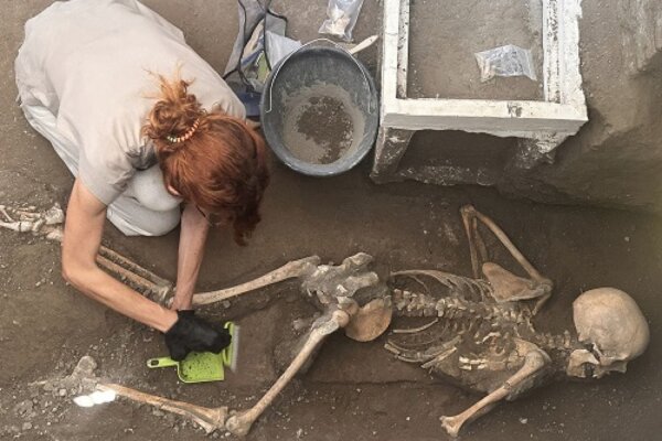 Researchers examine a new victim unearthed in the ancient city of Pompeii