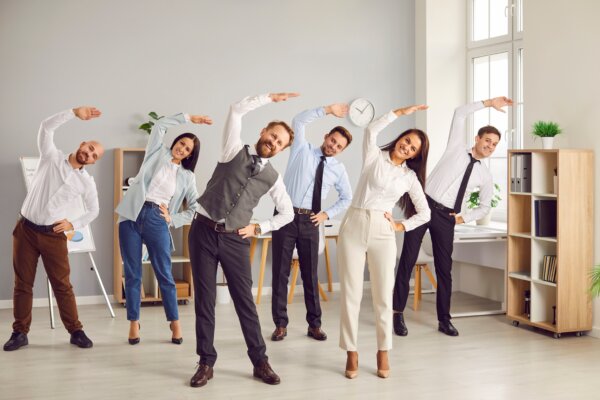 Group of smiling company employees exercising