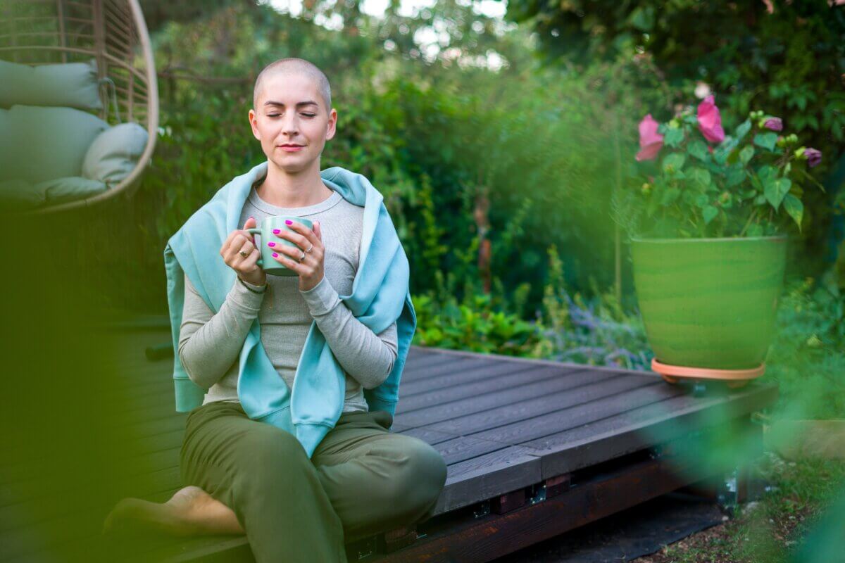 Female cancer patient sitting on garden patio