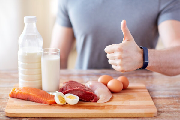 man with food rich in protein showing thumbs up