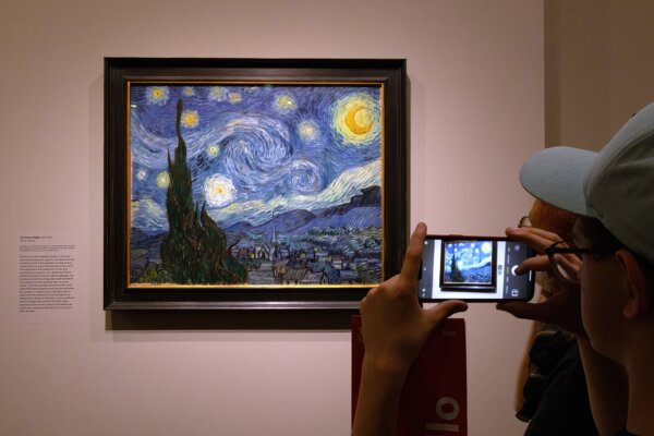 Tourist photographing a famous painting by Van Gogh