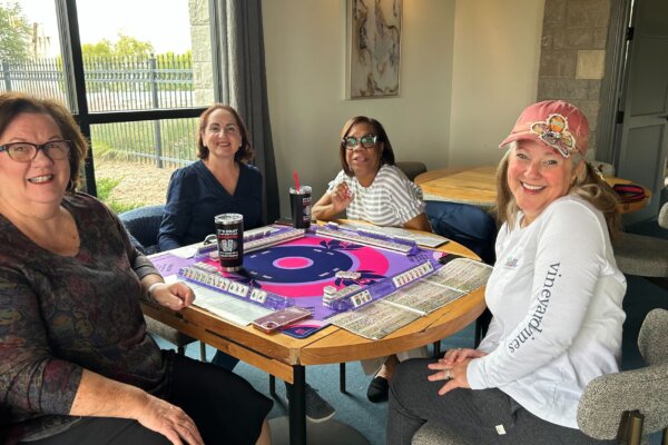 A group of women playing American Mahjong