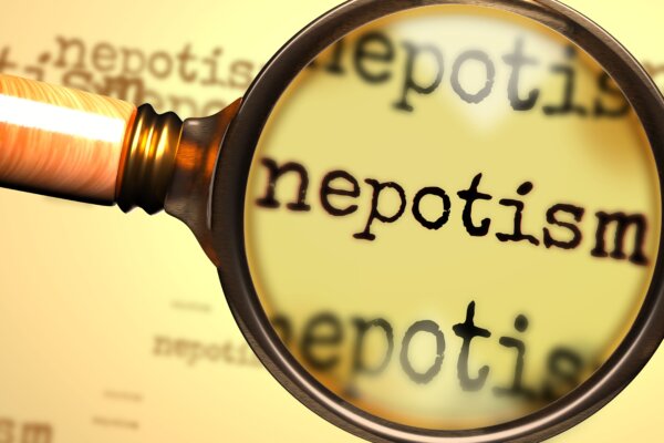 magnifying glass enlarging English word Nepotism