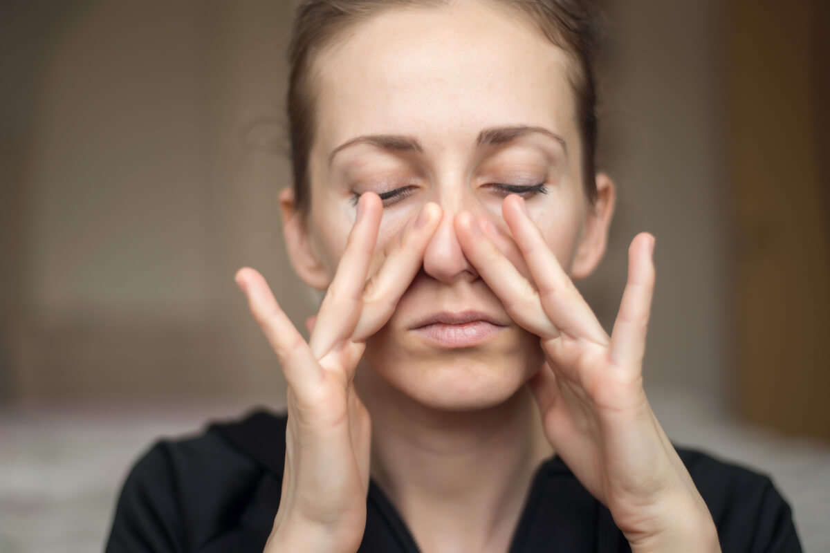 Young Woman Touches Nose