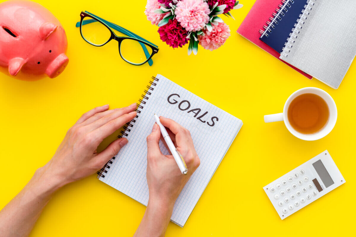 Someone writing down a list of goals