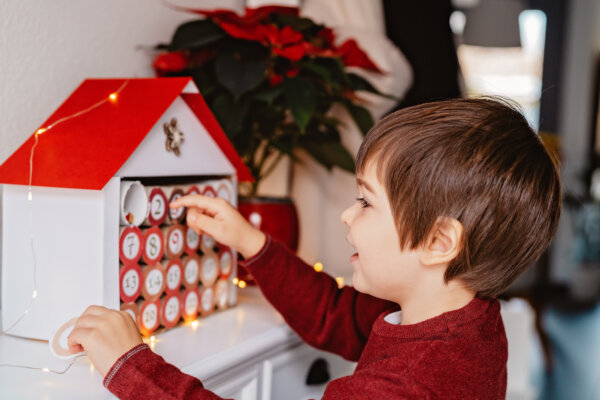 A little boy opening an advent calendar