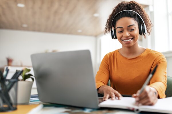 A woman using noise-canceling headphones at work