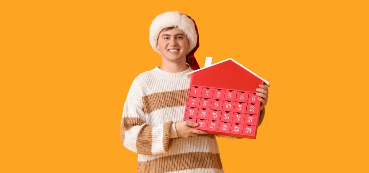 A young man holding an advent calendar