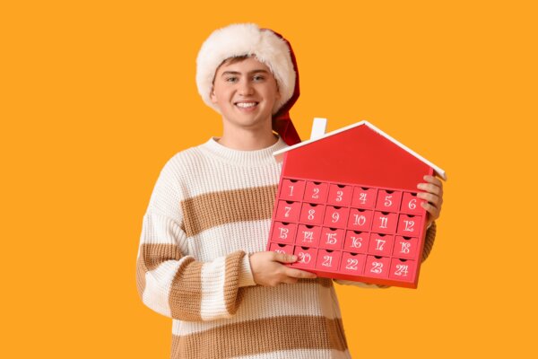 A young man holding an advent calendar