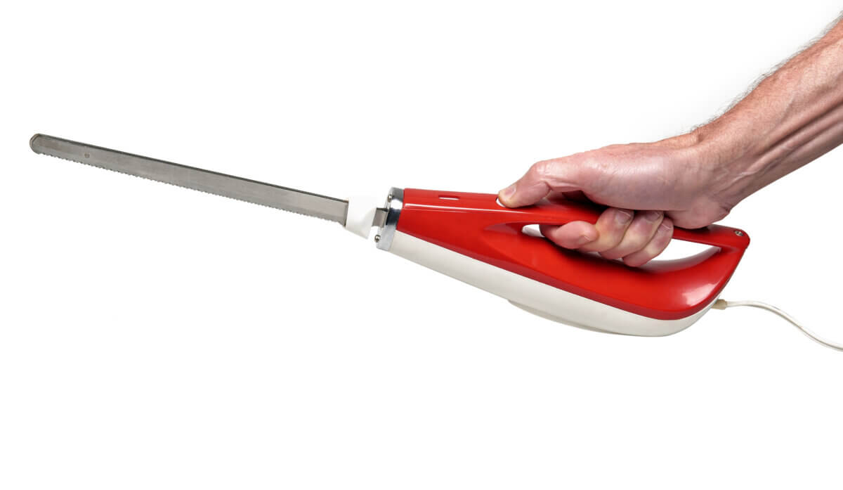A man holding an electric knife