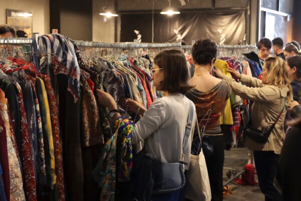 People buy vintage and second-hand clothes at a thrift shop