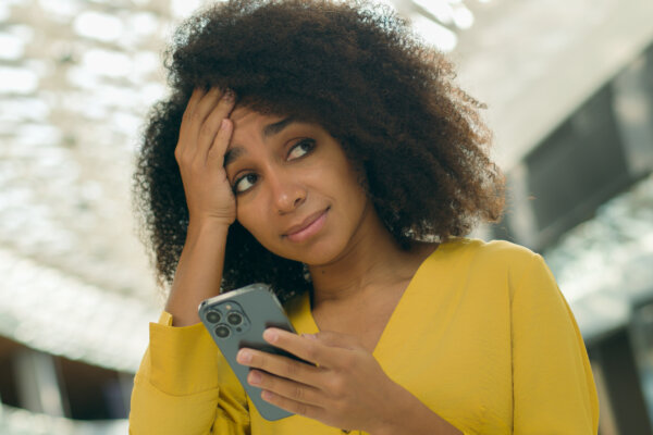 Woman stressed while using her smartphone