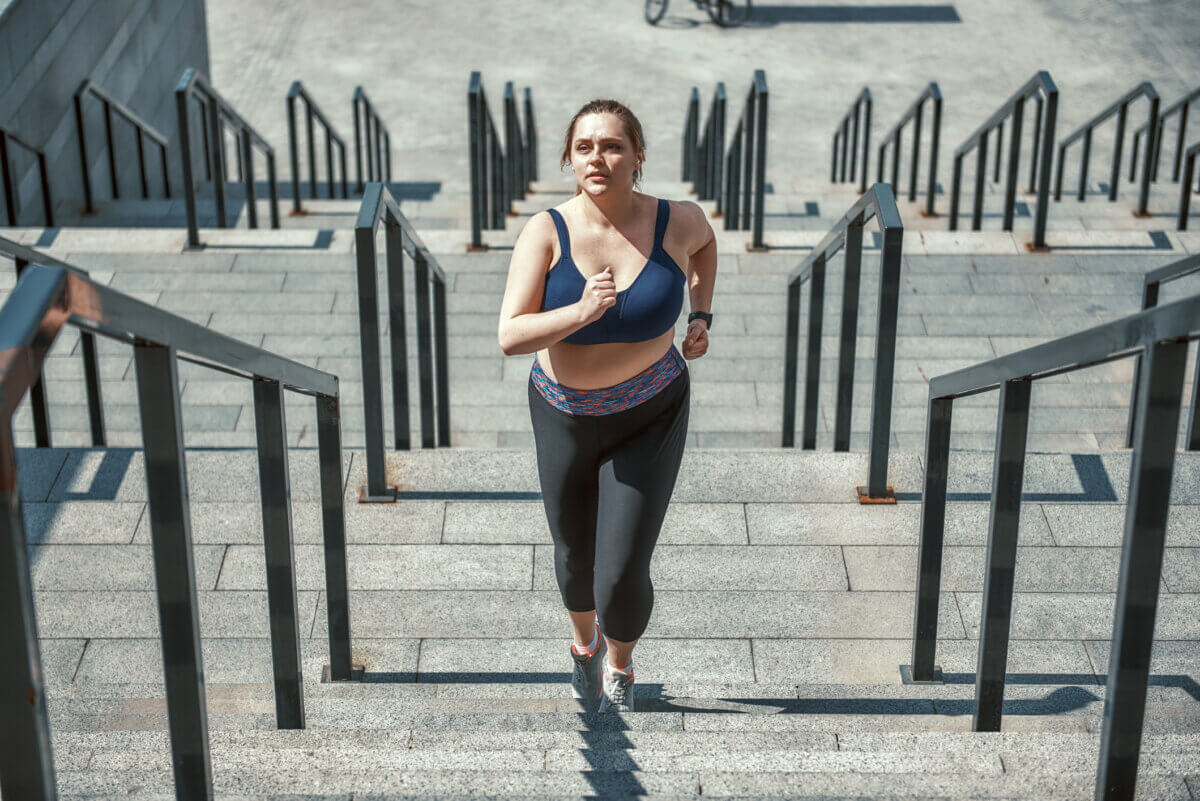 Woman getting aerobic exercise by running the stairs