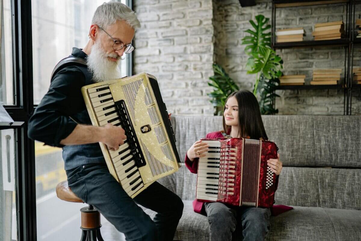 man teaching a girl to play accordion