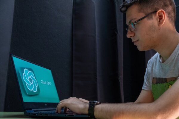 Young student using ChatGPT AI to help with studies.