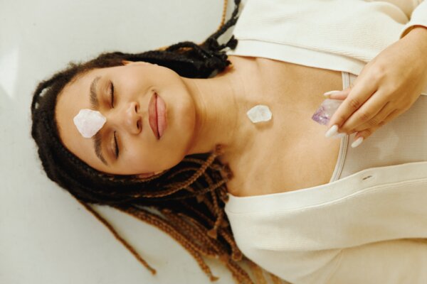 A woman meditating with crystals