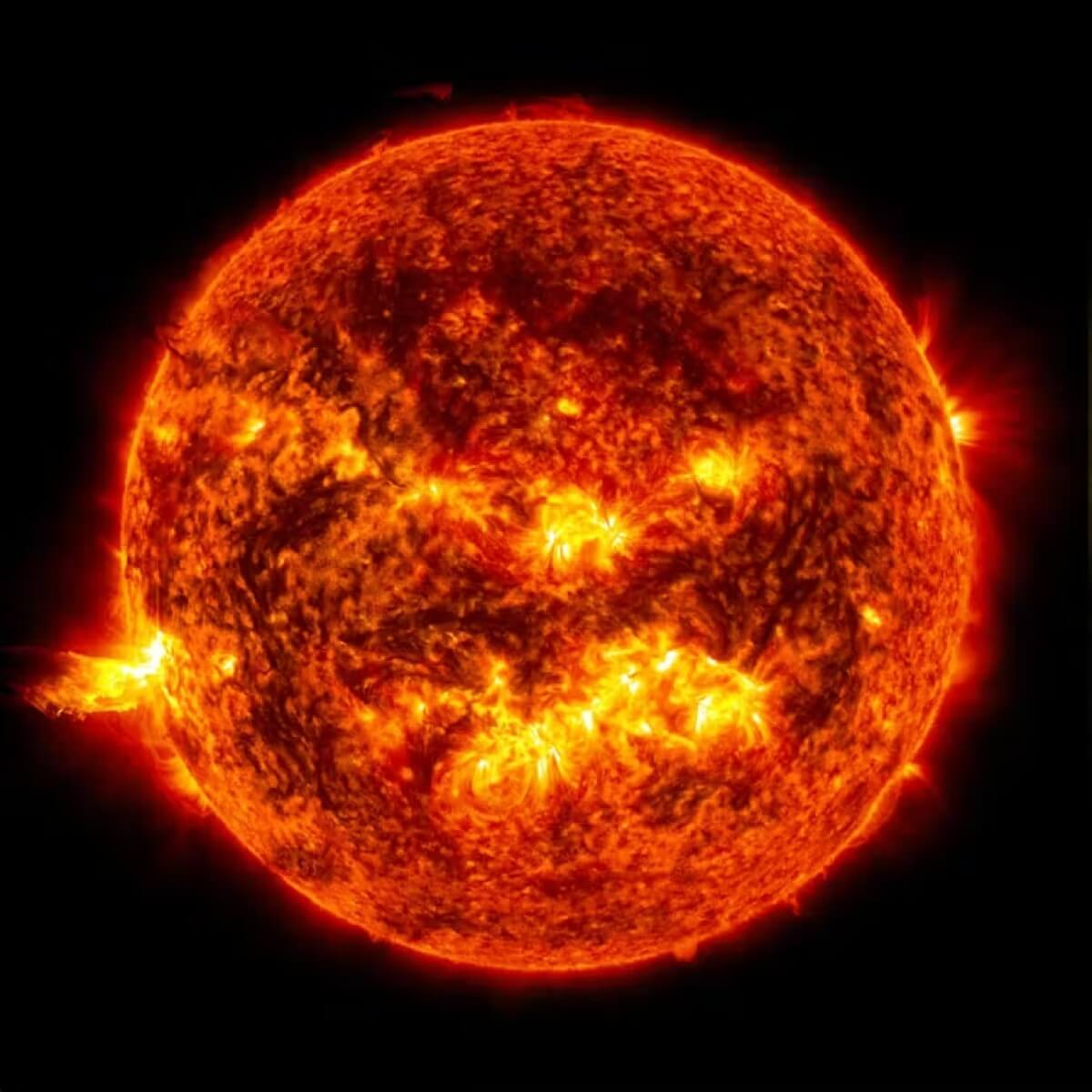 Image of the Sun as a bright solar flare seen on the left side. 