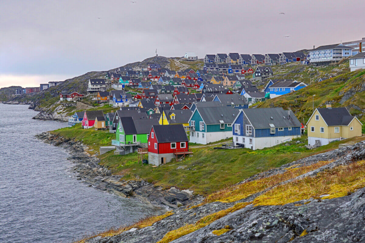 Colorful coastal houses in Nuuk Greenland under gray skies.